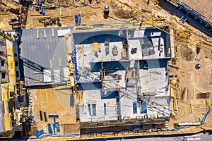 Crane and highrise construction site. aerial View