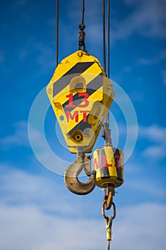 Crane hoist and hook with wire rope sling for lifting.