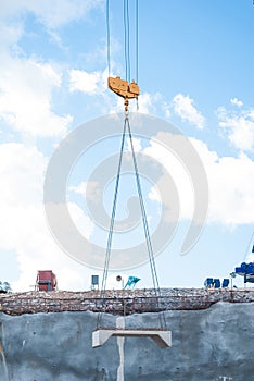 Crane hoisting concrete blocks photo
