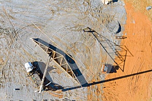 Crane holds detailed of eterior view of a new house under construction framing the beams stick