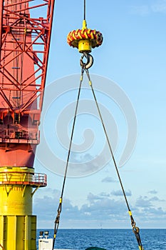 A crane hook lifting an anchor using 2 point bridal sling