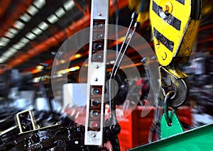 Crane hook of the overhead crane in the workshop of an industrial plant for the production of tractors and agricultural harvesters