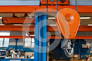 Crane hook. The system of pulleys and ropes, a hanging mechanism in the production area. Movement remote control pendant