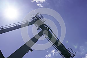 Crane for industrial handling of goods in the port with blue sky in the back