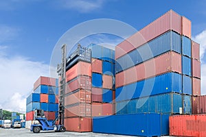 Crane lifter handling container box loading to truck.