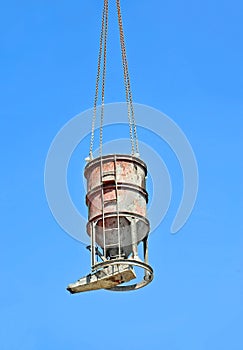 Crane lifting cement mixing container