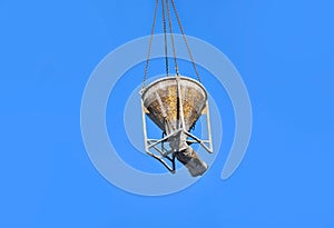 Crane lifting cement mixing container