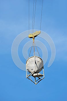 Crane lifting cement mixing container