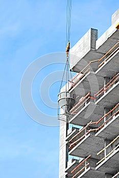 Crane lifting cement mixing container