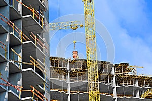 Crane lifting cement mixing container