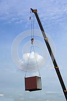 Crane lifting cutoff container moving in to the sky.