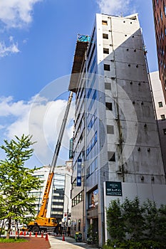 Crane lifting materials on an under construction building