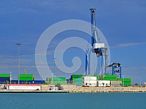 Crane lifting shipping container on cargo port harbour terminal