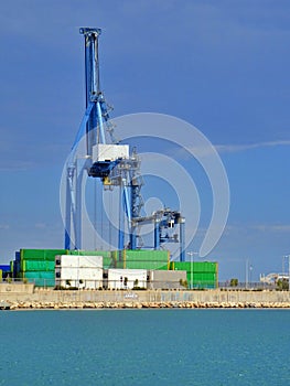 Crane lifting shipping container on cargo port harbour terminal