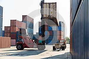 Crane lifting up container in railroad yard. Crane lifting up container in yard. forklift handling container box loading.