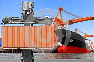 Crane lifting up container to commercial delivery cargo container truck and container ship being unloaded at the harbor