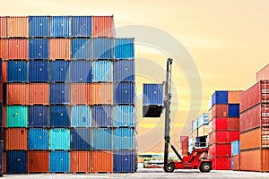 Crane lifting up container in yard