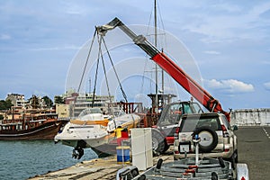 Crane lifts a boat