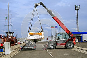 Crane lifts a boat