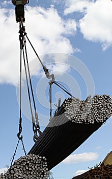 Crane lifts and moves a pack with metal reinforcement
