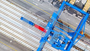 Crane loading container on a train, Rails in container port, Aerial view