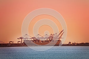 Crane loading containers on barge, Long Beach, USA