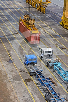 Crane lowering container.