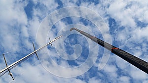 Crane mast up with blue sky and cloudy backgrounds