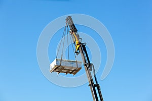 Crane moves large electrical component for radio wave repeater