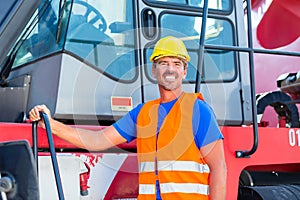 Crane operator standing on company yard