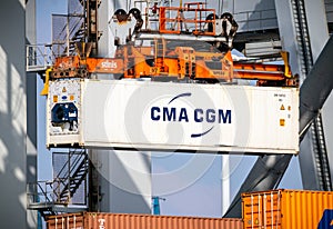 Crane operator unloading a refrigerated container from a cargo ship the Port of Rotterdam. The Netherlands - March 16, 2016