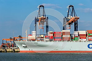 Crane operator unloading a sea container from a cargo ship the Port of Rotterdam. March 3, 2016
