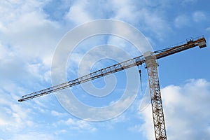 Crane, outdoor and clouds or blue sky background for building with heavy machinery or construction material. Hoist in