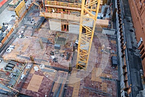 Crane rising through floor of highrise under construction