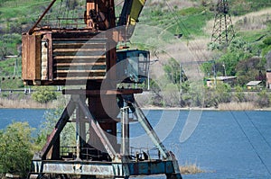 Crane in river port. Heavy cranes unloading metal to import. Steel delivery