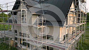 Crane shot of a single family house with solar panels under construction