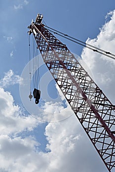 Crane silhouette against a blue and cloudy sky