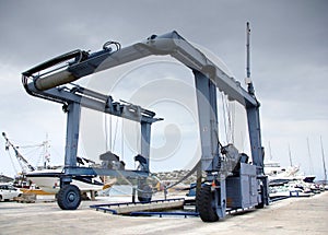 Crane to lifting boats at harbor, marina
