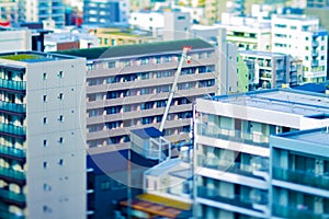 Crane at top of the building in Tokyo tiltshift