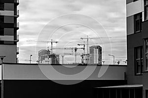 Crane tower at the construction site of a multi-storey residential building. Building concept