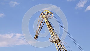 Crane tower with stretched cables against the sky