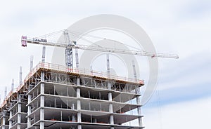 Crane towering over new building construction site