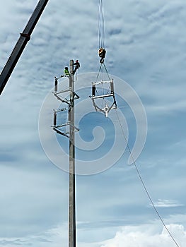 The crane truck is lifting of 115kV Disconnecting switch to the installation point