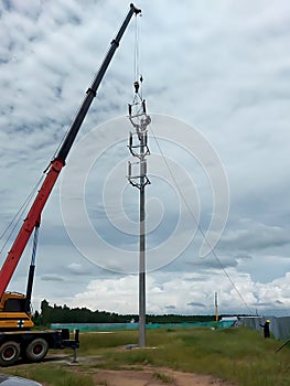 The crane truck is lifting of 115kV Disconnecting switch to the installation point photo