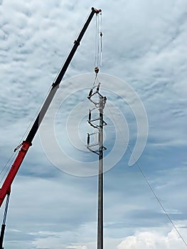 The crane truck is lifting of 115kV Disconnecting switch to the installation point photo