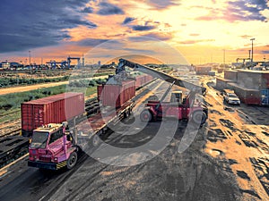 Crane trucks lift container in warehouse transportation port .