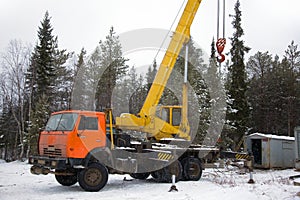 Crane working in the woods in winter