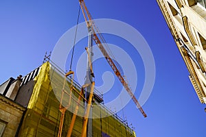 Crane yellow and building construction site against blue sky