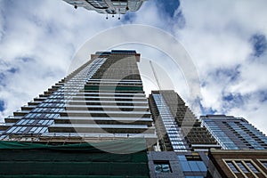 Cranes and building device on a construction site of a skyscraper in downtown Toronto, surrounded by other high rise towers