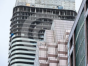 Cranes and building device on a construction site of a skyscraper in downtown Toronto, surrounded by other high rise towers